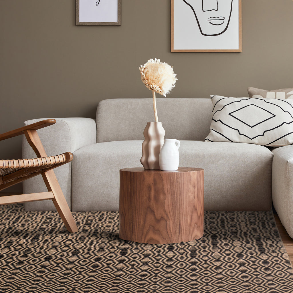 What does a black rug do to a room?