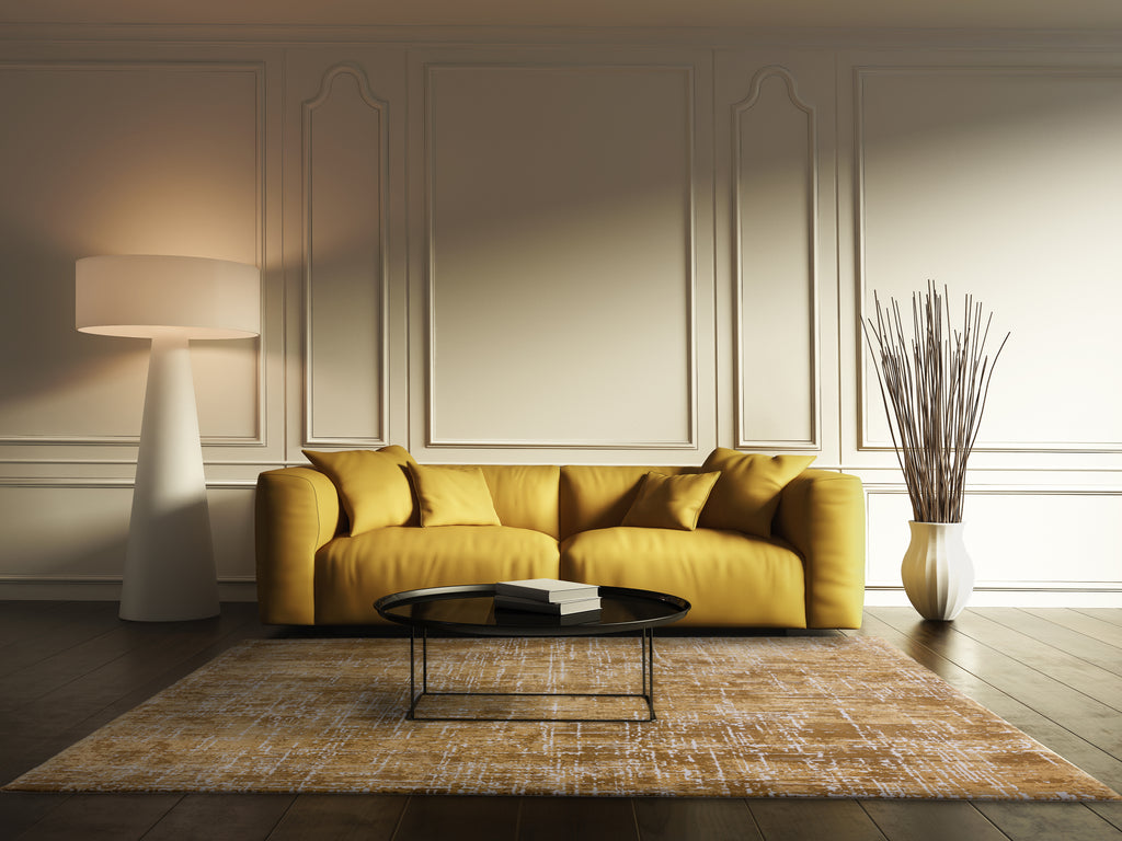 Should a rug match the sofa or walls?